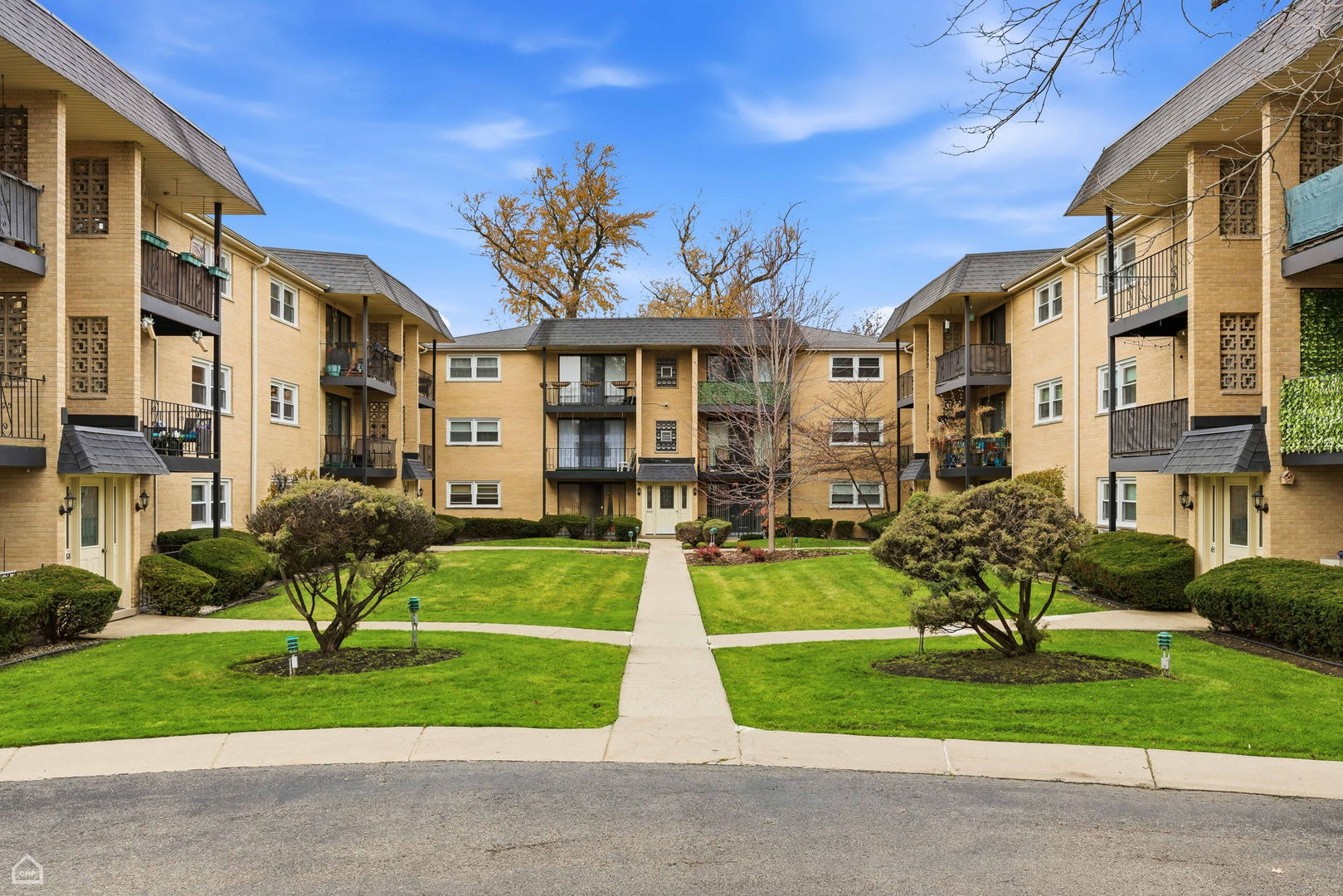 6568 West Roscoe Street, Unit 2N Chicago, IL 60634 - Photo 28 of 31 a view of a building with a yard