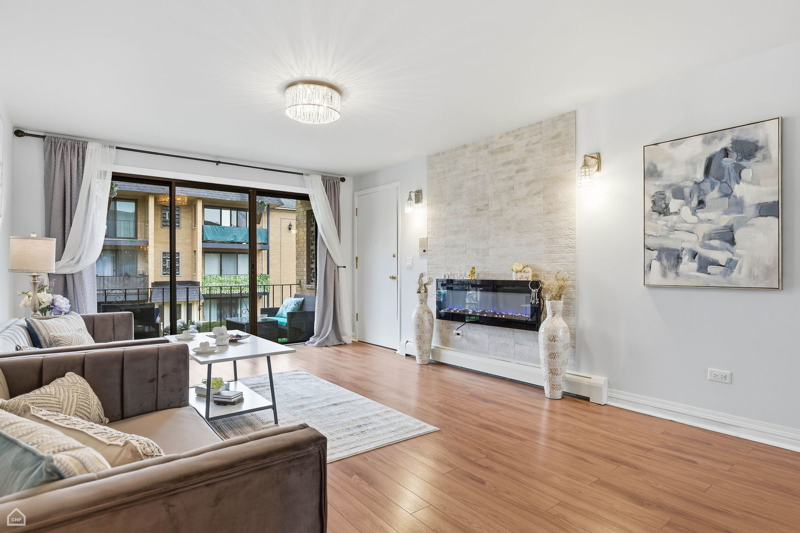 6568 West Roscoe Street, Unit 2N Chicago, IL 60634 - Photo 5 of 31 a living room with furniture and a large window