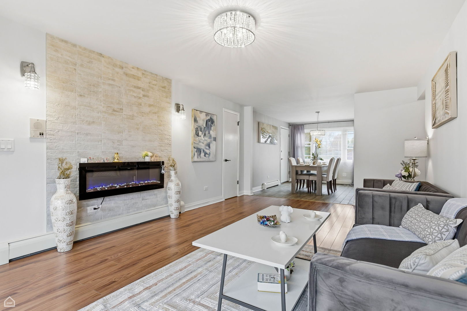 6568 West Roscoe Street, Unit 2N Chicago, IL 60634 - Photo 6 of 31 a living room with furniture and a fireplace