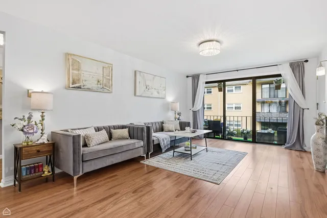 a living room with furniture a rug and a table