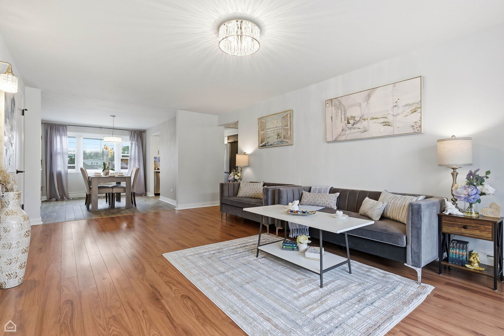 6568 West Roscoe Street, Unit 2N Chicago, IL 60634 - Photo 8 of 31 a living room with furniture and a wooden floor