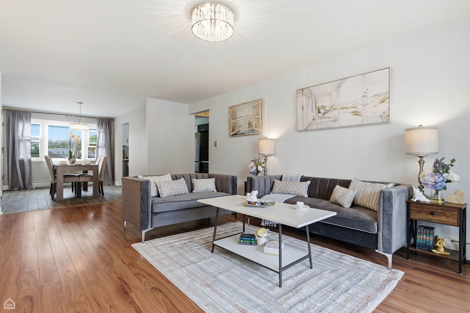 6568 West Roscoe Street, Unit 2N Chicago, IL 60634 - Photo 9 of 31 a living room with furniture a rug and a table