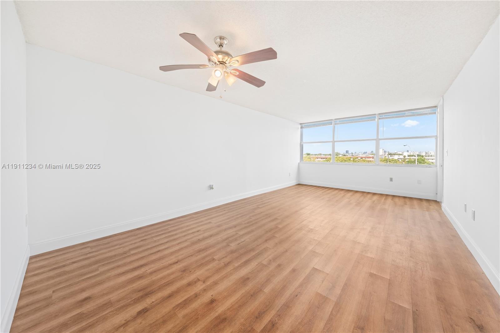 1300 Northeast Miami Gardens Drive, Unit 512E Miami, FL 33179 - Photo 15 of 22 a view of a room with wooden floor and window
