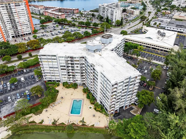 an aerial view of residential houses with yard