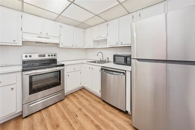 a view of a kitchen with a stove and a refrigerator
