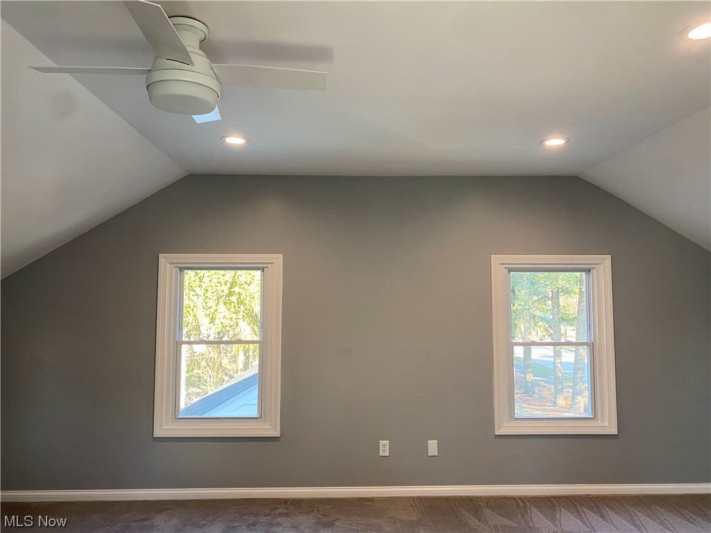 1147 Richmond Road Cleveland, OH 44124 - Photo 18 of 28 Additional living space with dark colored carpet, lofted ceiling, and ceiling fan