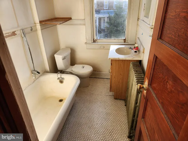 a bathroom with sink and mirror with bathtub