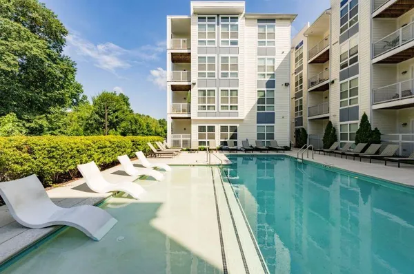 a swimming pool with outdoor seating and yard