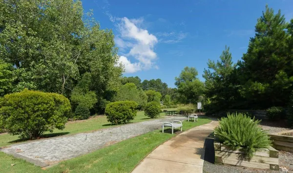 a view of a garden with an outdoor seating