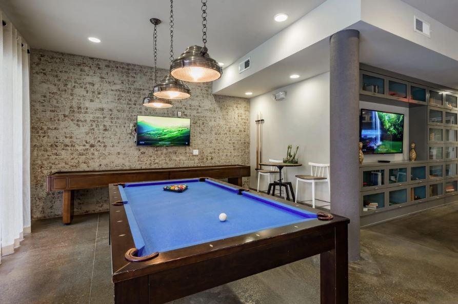 1391 Collier Road Northwest, Unit 2105 Atlanta, GA 30318 - Photo 29 of 43 a room with pool table and a wooden floor