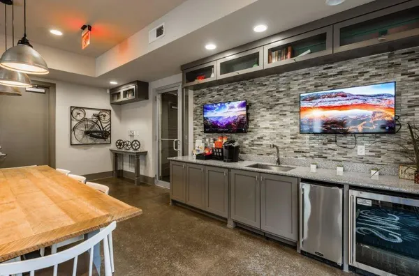 a kitchen with stainless steel appliances wooden cabinets a stove and a microwave