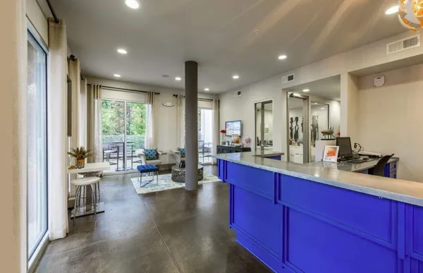 a large living room with stainless steel appliances granite countertop furniture a large window and a sink