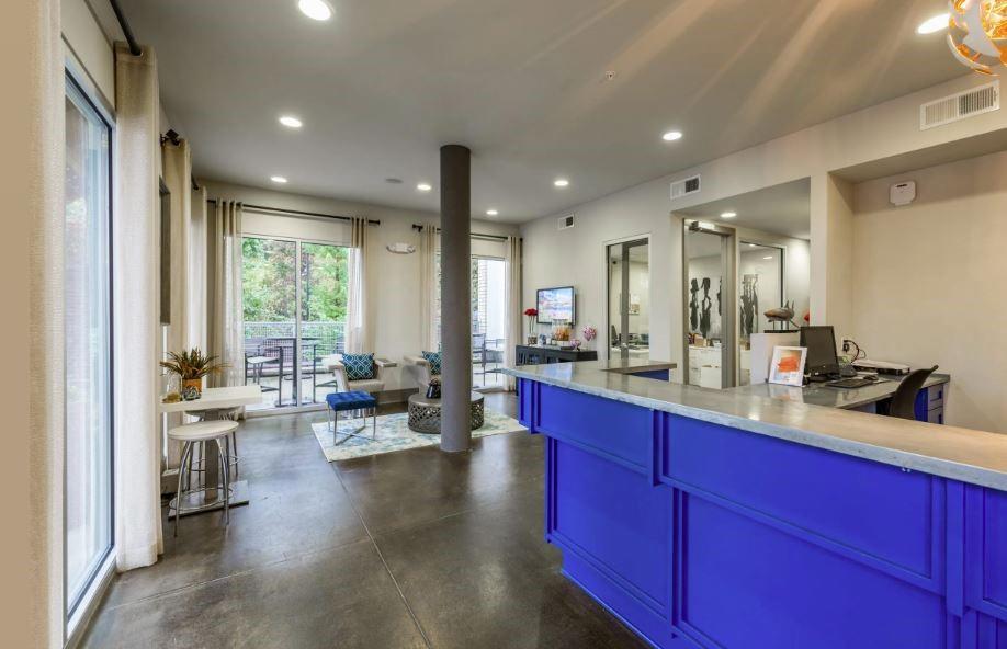 1391 Collier Road Northwest, Unit 2105 Atlanta, GA 30318 - Photo 39 of 43 a large living room with stainless steel appliances granite countertop furniture a large window and a sink