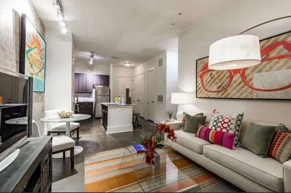 a living room with furniture kitchen view and a fireplace