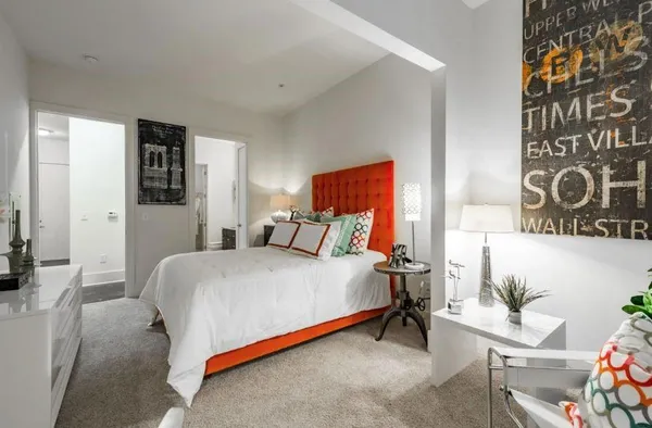 a bedroom with a bed and a chair