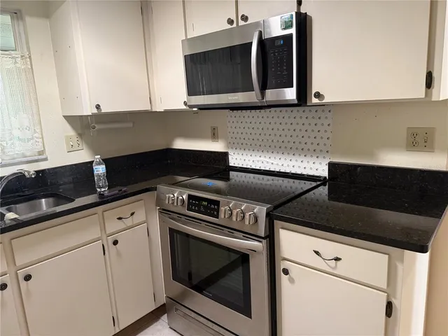 a kitchen with a sink and a microwave