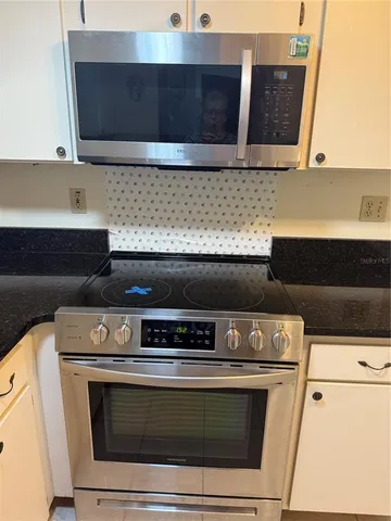 a stove top oven sitting inside of a kitchen