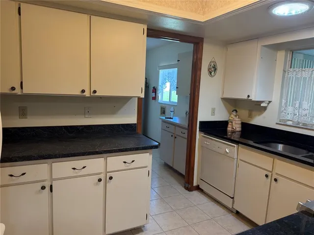 a kitchen with stainless steel appliances a sink and cabinets