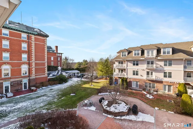 a view of a big house with a yard and balcony