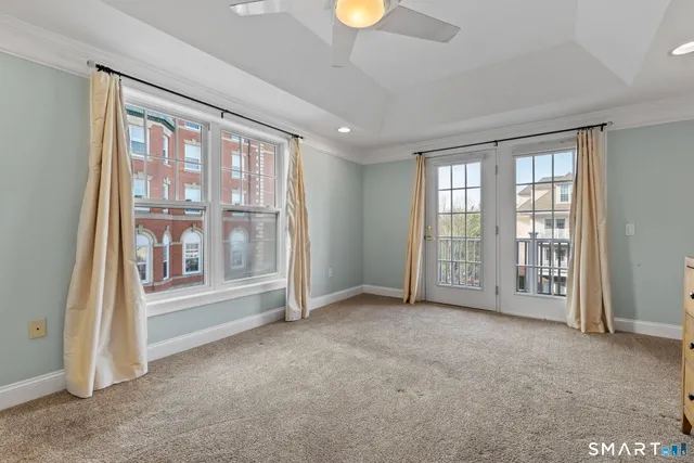 a view of an empty room with a fireplace and a window