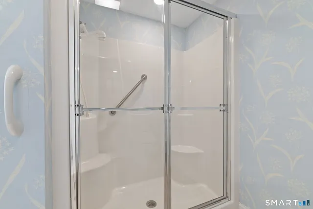 a bathroom with a glass shower door