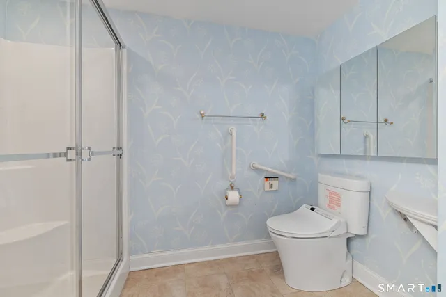 a white toilet sitting next to a bathroom sink