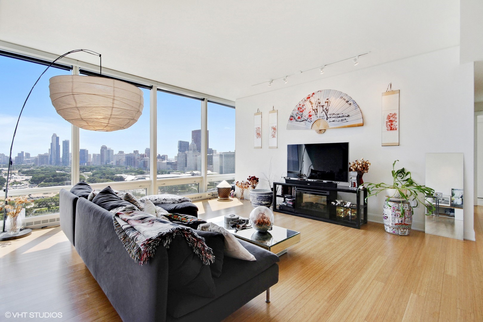 340 East Randolph Street, Unit 1803 Chicago, IL 60601 - Photo 2 of 19 a living room with furniture and a flat screen tv