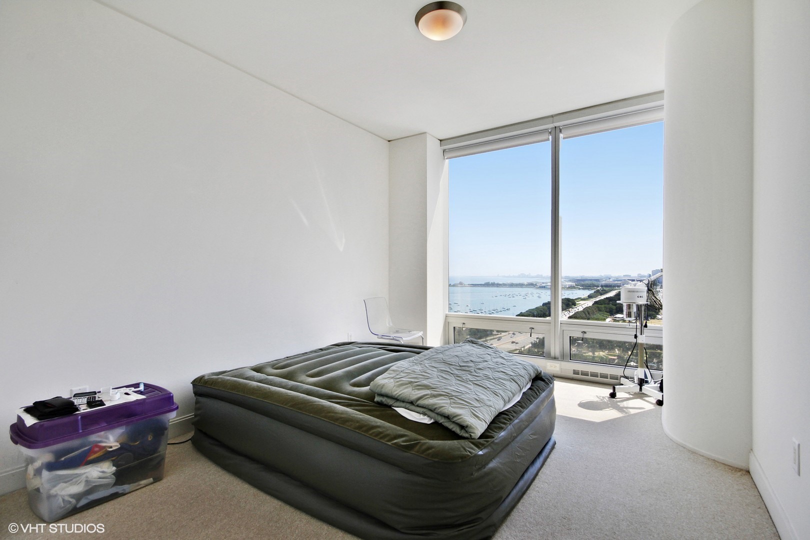 340 East Randolph Street, Unit 1803 Chicago, IL 60601 - Photo 11 of 19 a living room with a bed and furniture