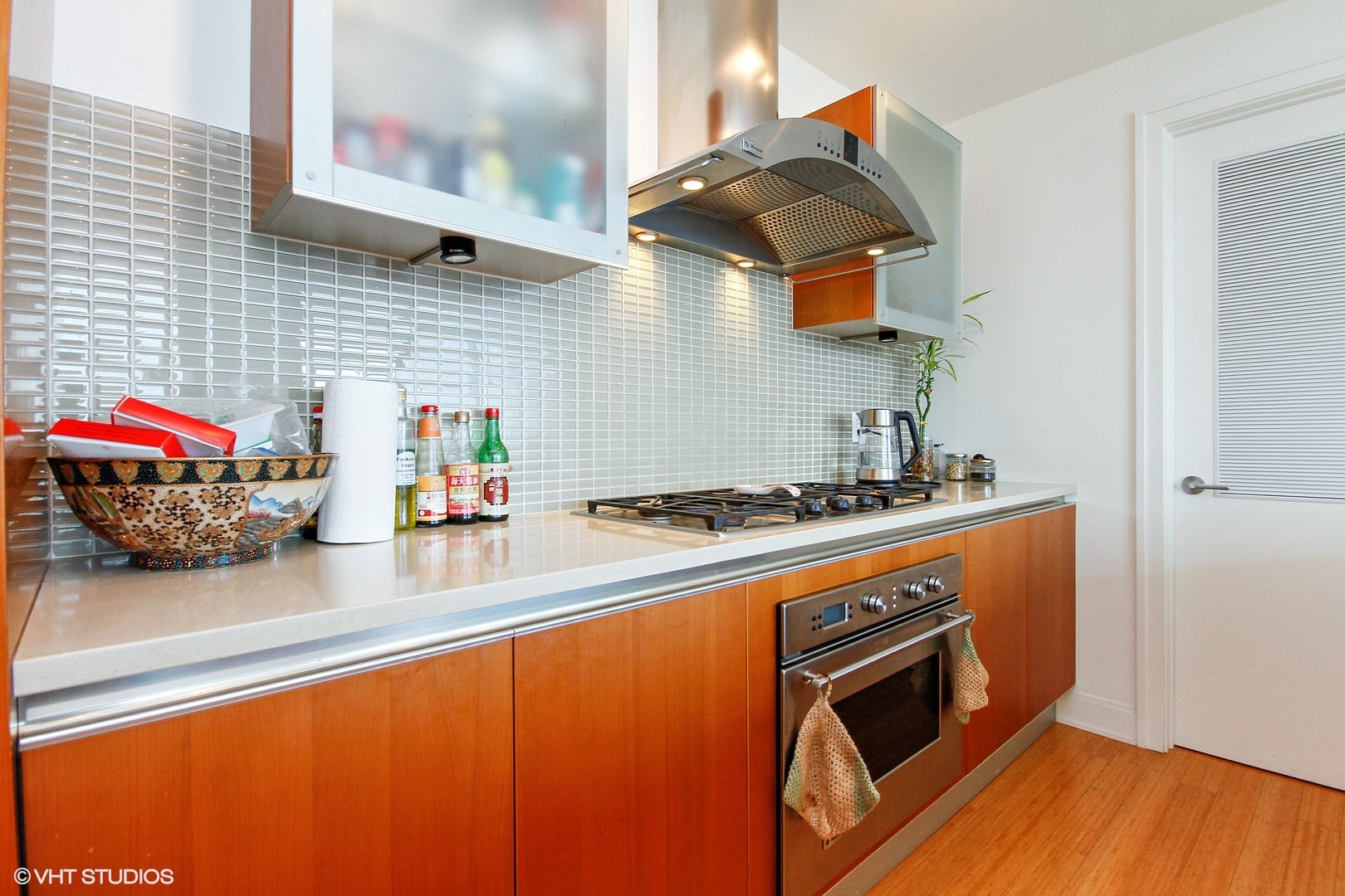 340 East Randolph Street, Unit 1803 Chicago, IL 60601 - Photo 5 of 19 a kitchen with stainless steel appliances granite countertop a stove and a microwave