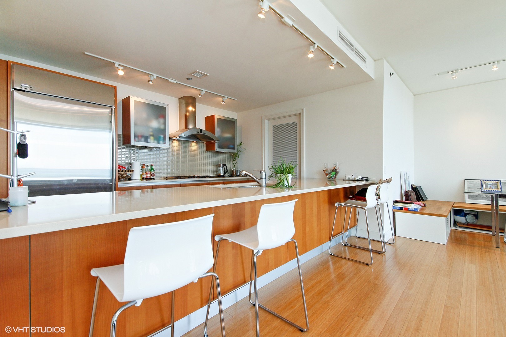 340 East Randolph Street, Unit 1803 Chicago, IL 60601 - Photo 6 of 19 a living room with stainless steel appliances kitchen island granite countertop furniture and a large window