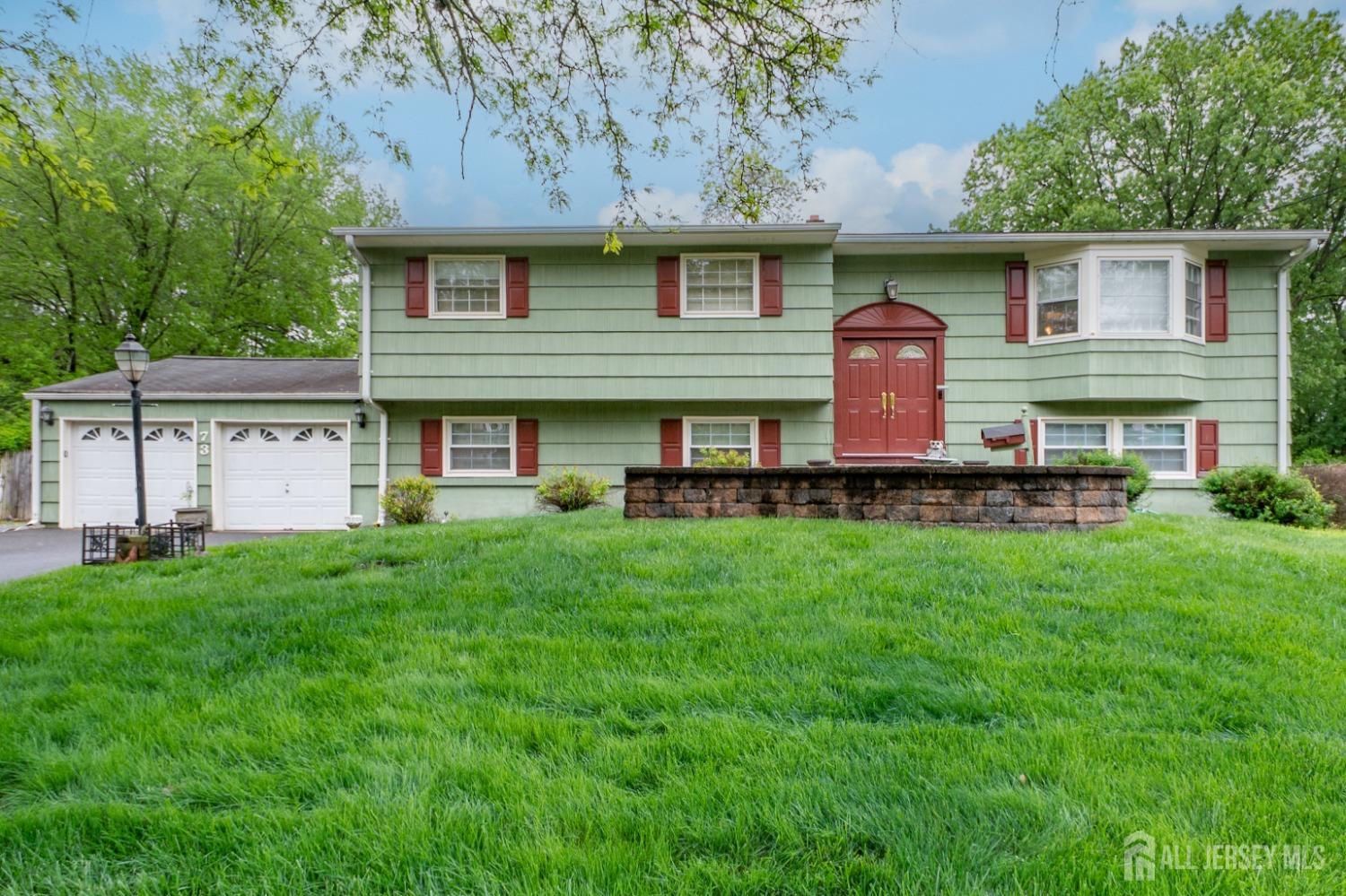 a front view of house with yard and green space