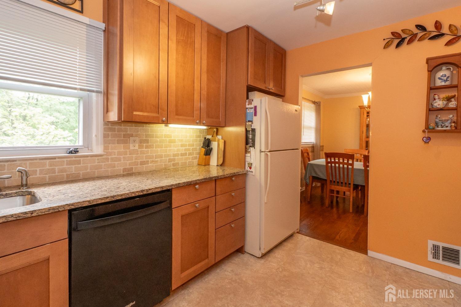 73 Wellington Road East Brunswick, NJ 08816 - Photo 11 of 39 a kitchen with stainless steel appliances a sink cabinets and a window