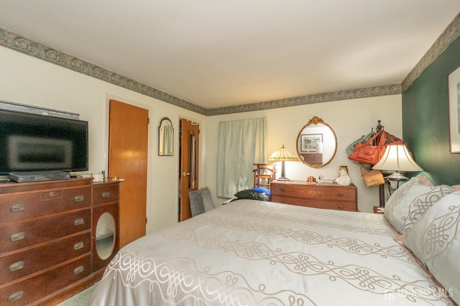 73 Wellington Road East Brunswick, NJ 08816 - Photo 13 of 39 a bedroom with a bed and flat screen tv