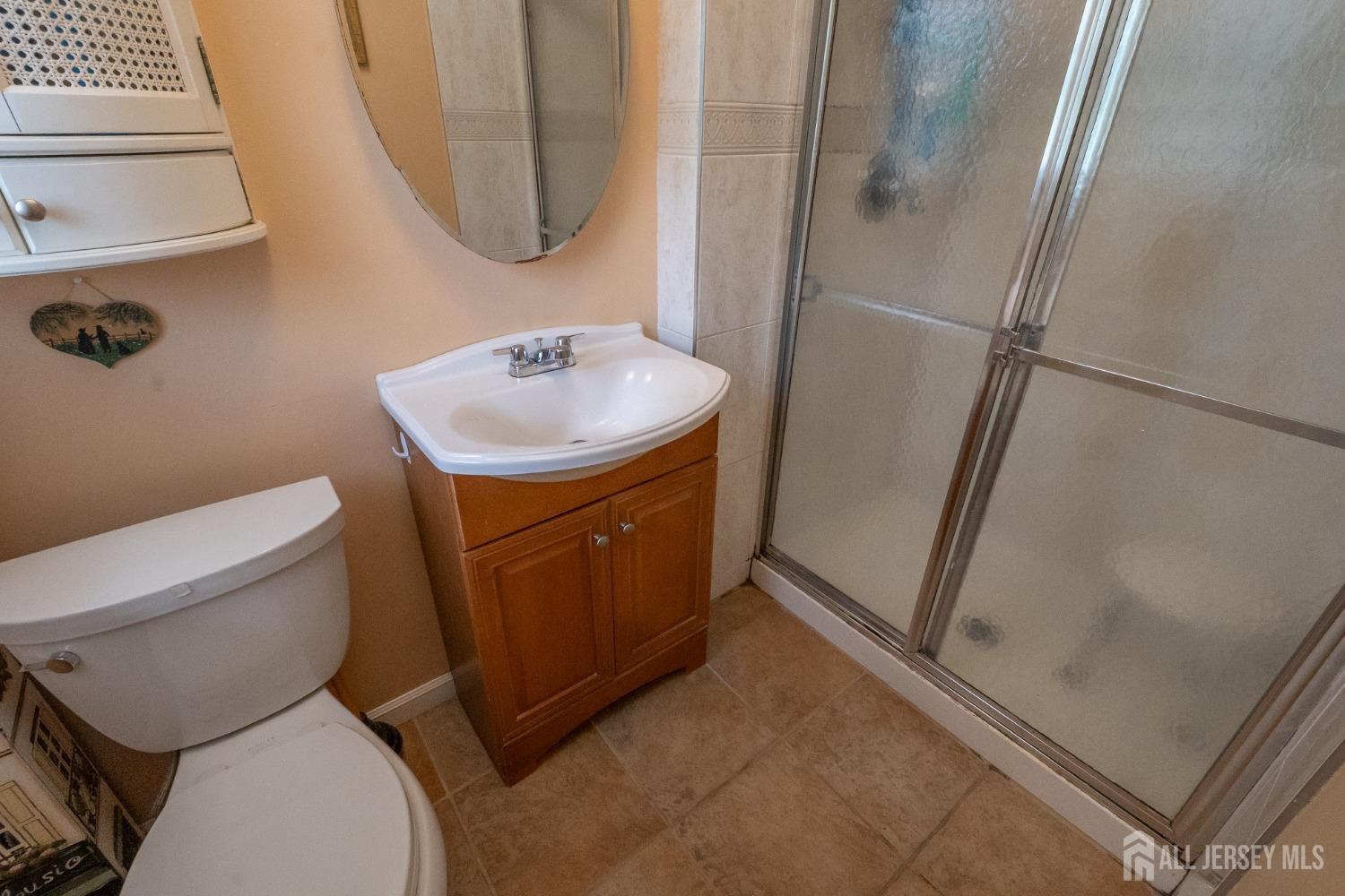 73 Wellington Road East Brunswick, NJ 08816 - Photo 14 of 39 a bathroom with a sink toilet and shower