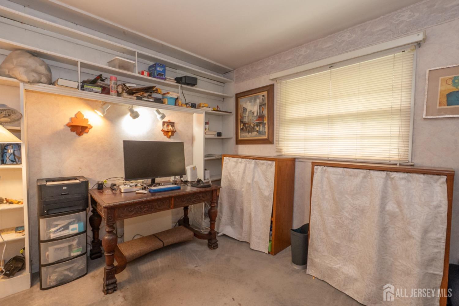 73 Wellington Road East Brunswick, NJ 08816 - Photo 18 of 39 a view of a workspace with furniture and a window