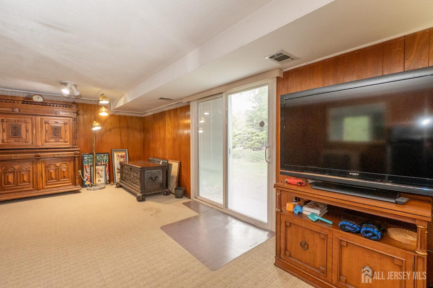 73 Wellington Road East Brunswick, NJ 08816 - Photo 19 of 39 a living room with furniture and a flat screen tv