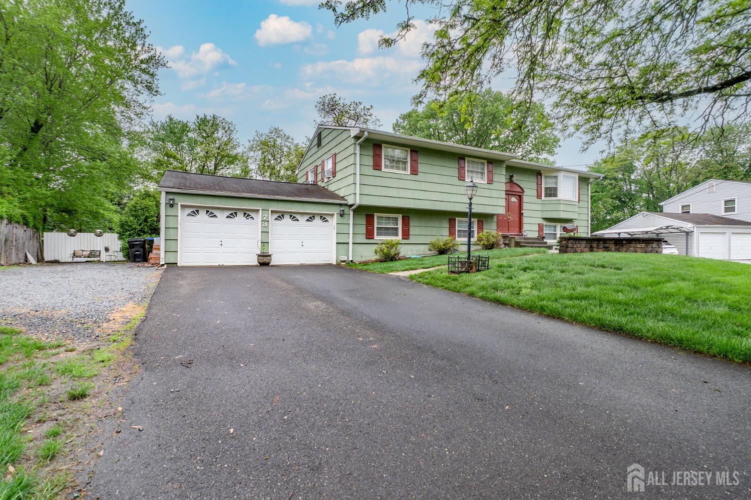 73 Wellington Road East Brunswick, NJ 08816 - Photo 2 of 39 a front view of a house with a garden and yard