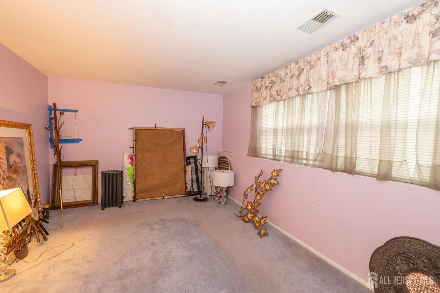 73 Wellington Road East Brunswick, NJ 08816 - Photo 22 of 39 a bed room with a bed and a chair