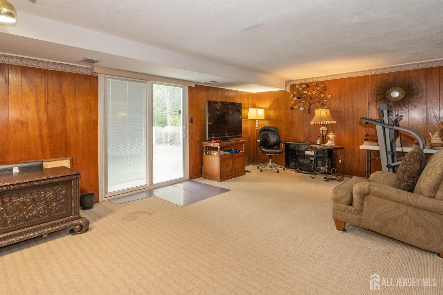 73 Wellington Road East Brunswick, NJ 08816 - Photo 23 of 39 a view of a livingroom with furniture and a flat screen tv