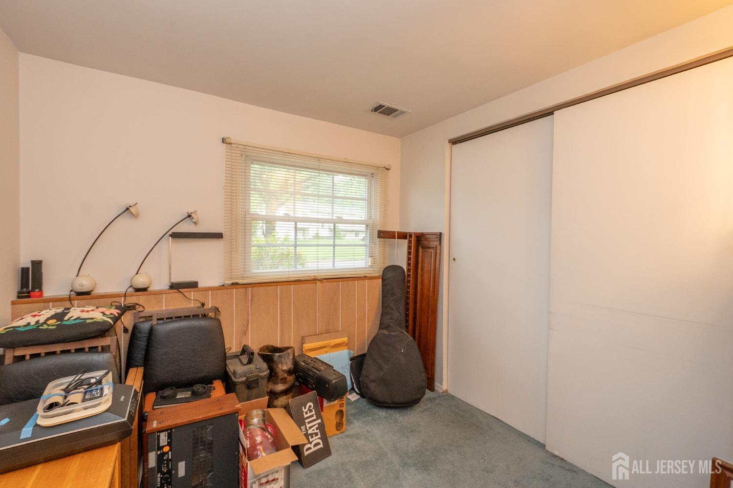 73 Wellington Road East Brunswick, NJ 08816 - Photo 24 of 39 a room with furniture and two windows