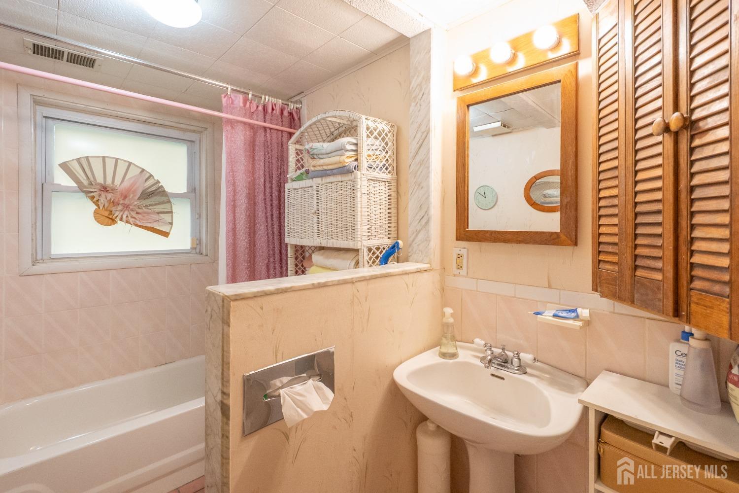 73 Wellington Road East Brunswick, NJ 08816 - Photo 26 of 39 a bathroom with a sink and a mirror