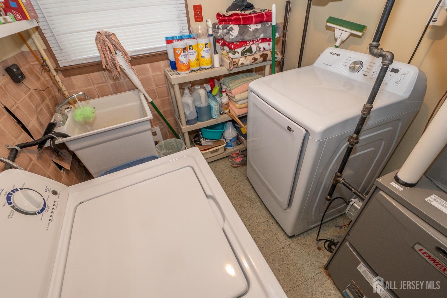 73 Wellington Road East Brunswick, NJ 08816 - Photo 29 of 39 a utility room with dryer and washer