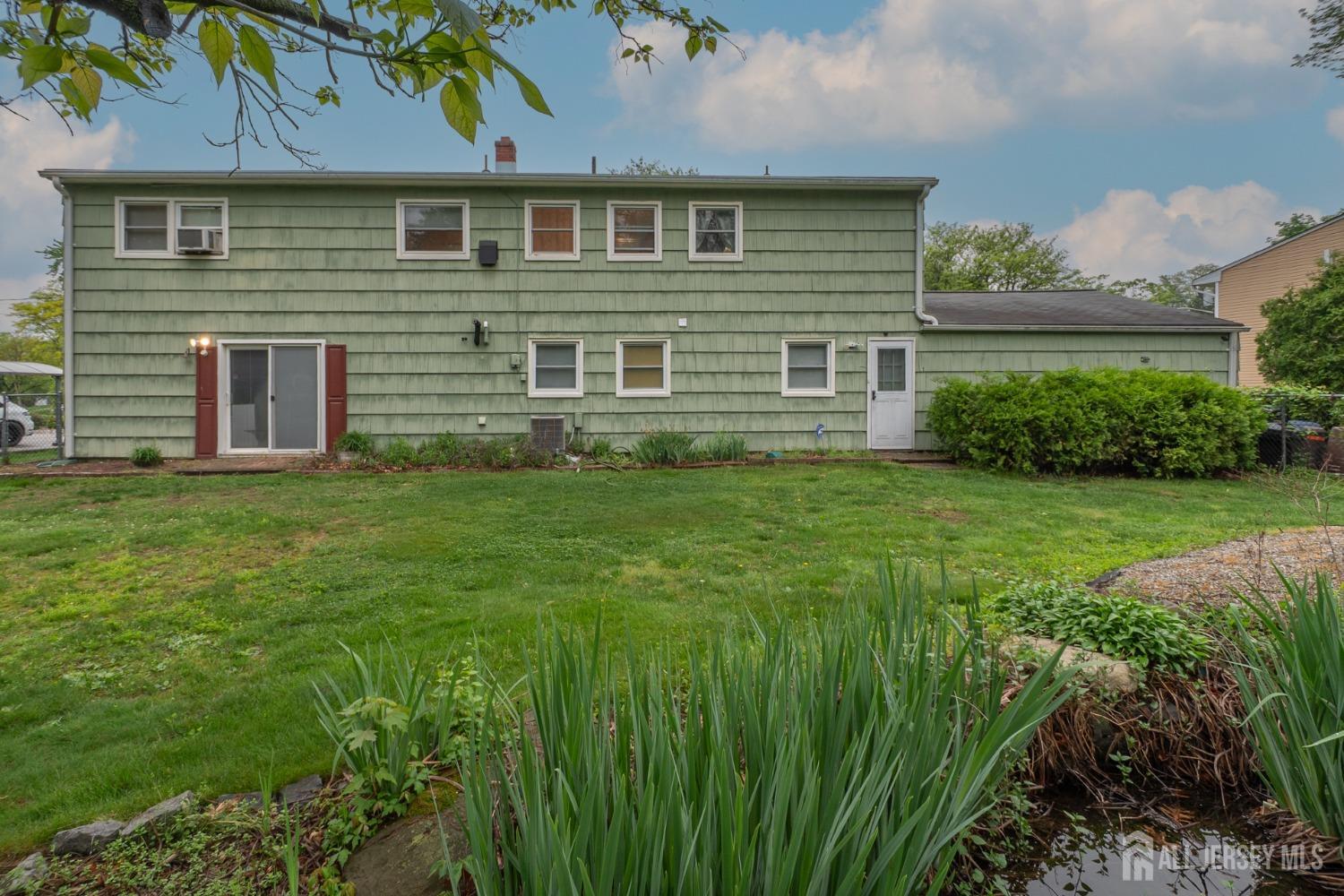 73 Wellington Road East Brunswick, NJ 08816 - Photo 32 of 39 a front view of a house with a yard