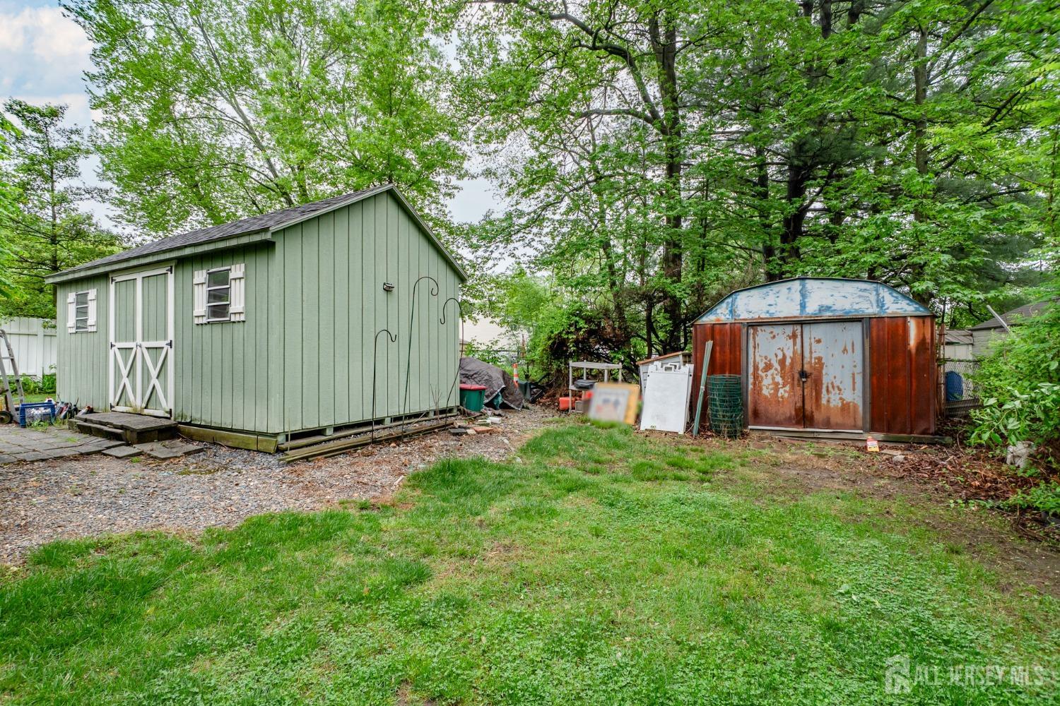73 Wellington Road East Brunswick, NJ 08816 - Photo 33 of 39 a backyard of a house with wooden fence and large trees