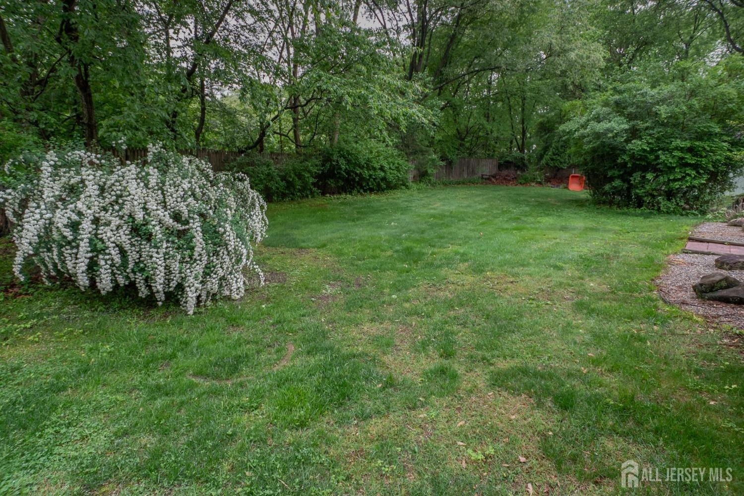 73 Wellington Road East Brunswick, NJ 08816 - Photo 35 of 39 a view of a green field with trees in the background