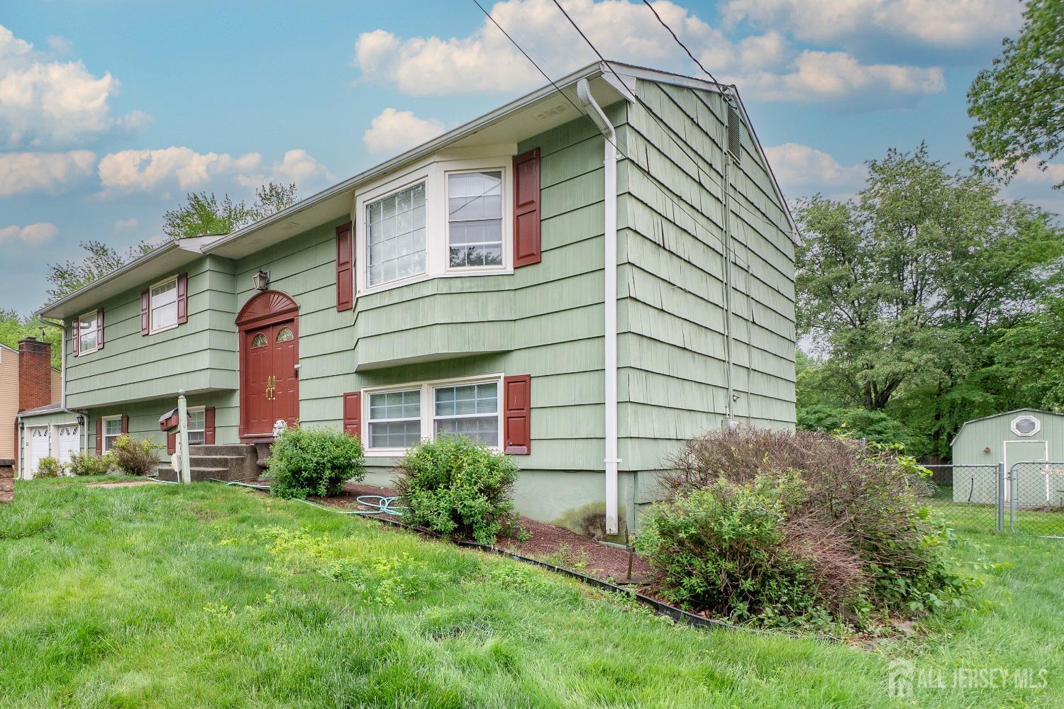 73 Wellington Road East Brunswick, NJ 08816 - Photo 4 of 39 a backyard of a house with plants and barbeque oven