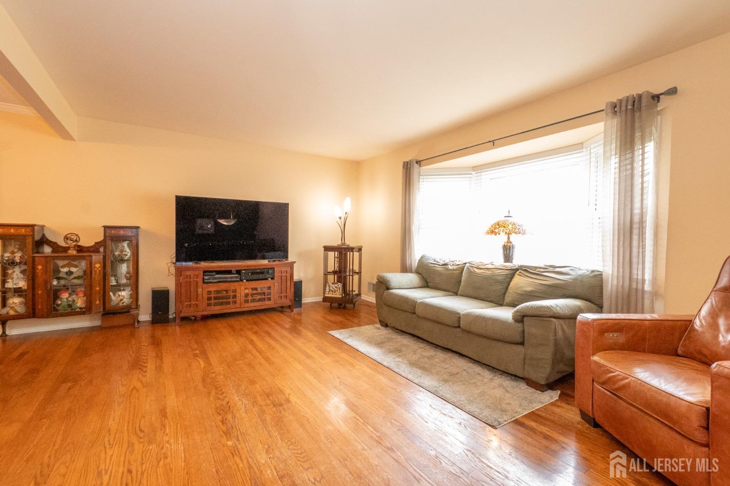 73 Wellington Road East Brunswick, NJ 08816 - Photo 6 of 39 a living room with furniture and a flat screen tv