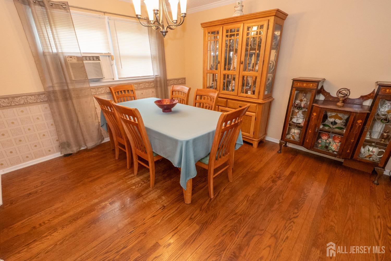 73 Wellington Road East Brunswick, NJ 08816 - Photo 8 of 39 a view of a dining room with furniture and wooden floor