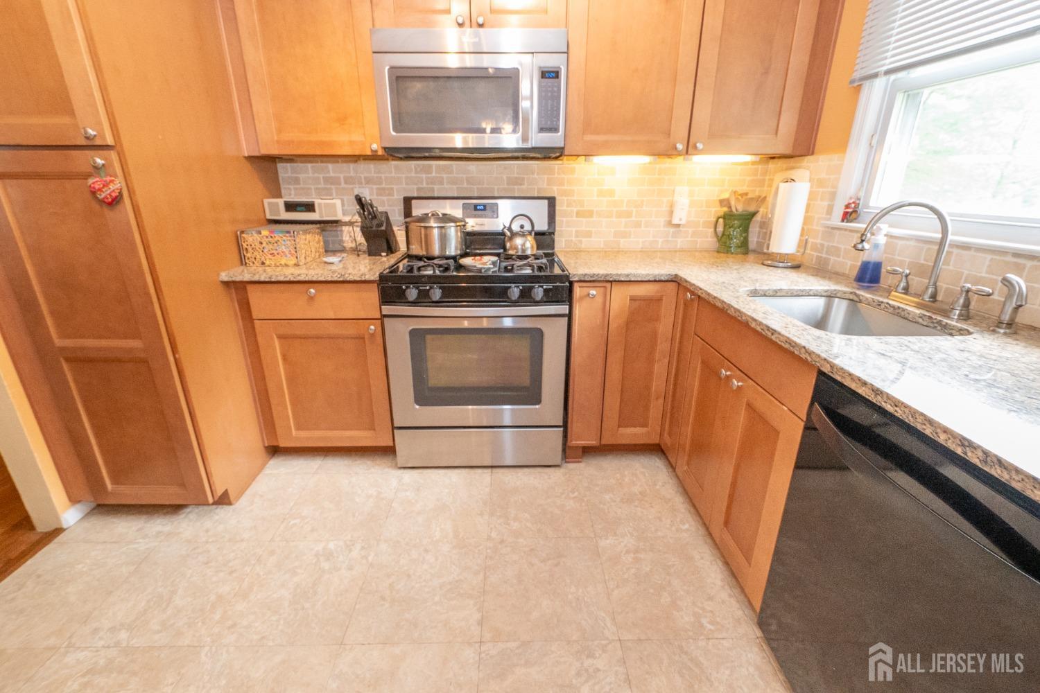 73 Wellington Road East Brunswick, NJ 08816 - Photo 10 of 39 a kitchen with a sink stove and refrigerator