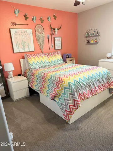 a bed sitting in a bedroom next to a lamp